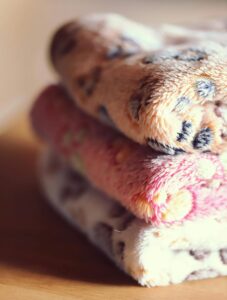 Soft layered blankets symbolizing comfort and sensitivity during triple negative breast cancer recovery and neuropathy.