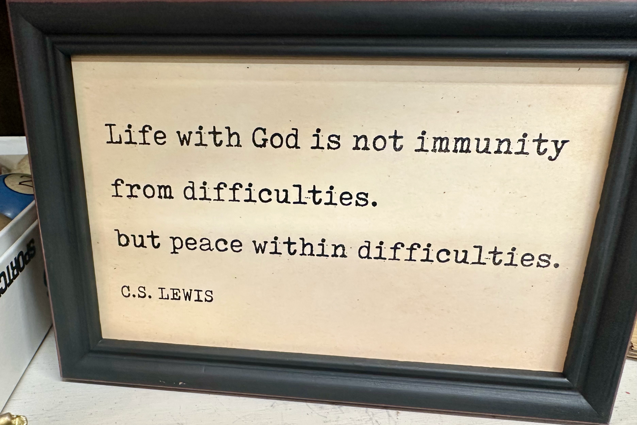 Framed quote by C.S. Lewis about finding peace with God amid difficulties.