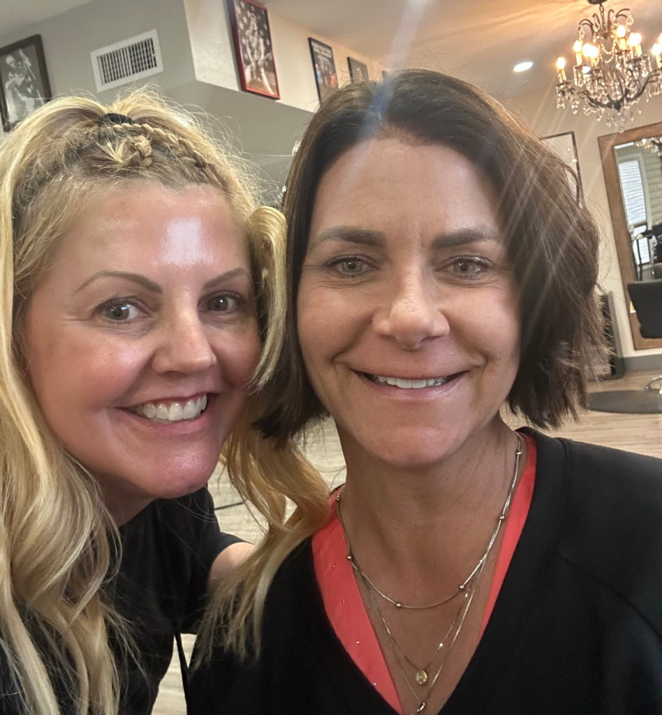 Friends together at hair salon, first cut during chemo